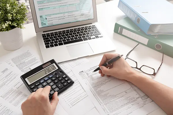A paper invoice sitting in a desk tray waiting for a signature.